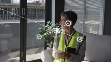 Animation of network of connections over caucasian female engineer using smartphone. global business, connections and technology concept digitally generated video.