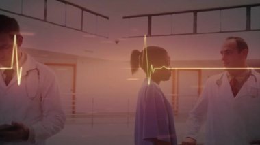 Animation of glowing heart rate monitor over diverse doctors. Global healthcare services, health and data processing concept digitally generated video.