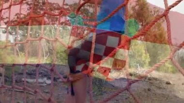 Animation of flag of netherlands over caucasian woman during obstacle race training. national sports, activity and patriotism concept digitally generated video.