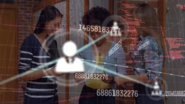 Animation of data processing over diverse businesswomen in office. Global business and digital interface concept digitally generated video.