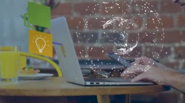 Animation of globe of network of connections over caucasian businessman using smartphone and laptop. global business, connections, technology and digital interface concept digitally generated video.