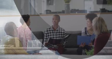 Digital composite image of multiracial colleagues discussing in modern office, city in foreground. Multiple exposure, business, meeting, teamwork.