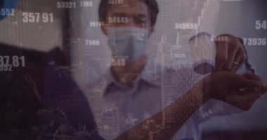 Animation of cityscape and data processing over diverse business people wearing face masks. Global business, covid 19 pandemic and digital interface concept digitally generated video.