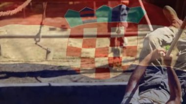Animation of flag of croatia over diverse male soldiers during training. army, defense and patriotism concept digitally generated video.