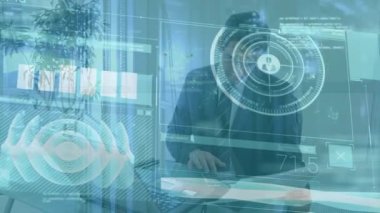 Animation of interface with data processing over caucasian businessman using calculator at office. Computer interface and business technology concept