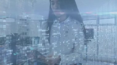 Animation of screens with mosaic squares over biracial businesswoman using digital tablet at office. Global networking and business technology concept