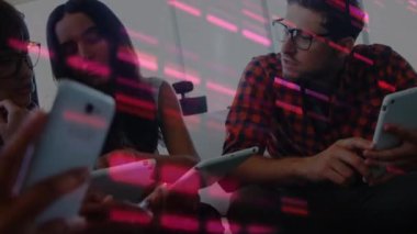 Animation of pink mosaic squares over diverse colleagues using electronic devices at office. Computer interface and business technology concept