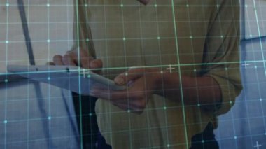 Animation of grid network over mid section of a woman using digital tablet at office. Computer interface and business technology concept