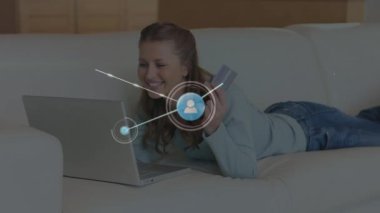 Animation of network of connections with icons over caucasian woman using laptop. Global technology, connections and digital interface concept digitally generated video.