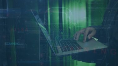Animation of cyber attack warning with padlock icon over hacker using laptop in server room. Global technology, online security and digital interface concept digitally generated video.