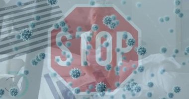 Animation of covid-19 cells and stop signboard over sick caucasian senior woman sitting on bed. Covid-19 pandemic concept