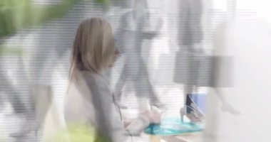 Animation of caucasian businesswoman working at desk over time lapse of people walking on street. Digital composite, multiple exposure, entrepreneur, report, profession, office and technology concept.