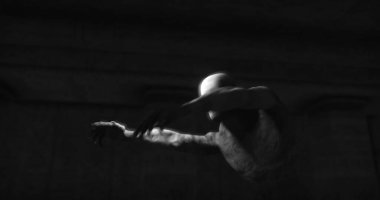 Image of scary zombie mummy walking in dark room with burning torches, in black and white. Halloween fear, horror and suspense concept digitally generated image.