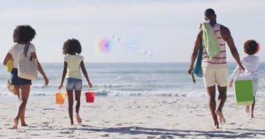 Animation of light trails over african american family at beach. Lifestyle and free time concept digitally generated video.