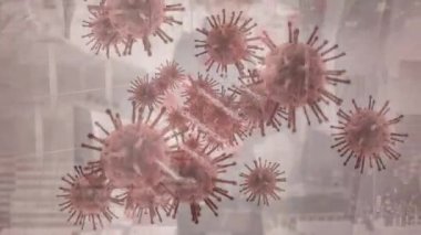 Animation of virus cells and dna strand over diverse business people and cityscape. Global covid 19 pandemic and digital interface concept digitally generated video.