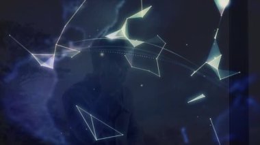 Animation of globe and shapes over caucasian man using smartphone. Global business and digital interface concept digitally generated video.