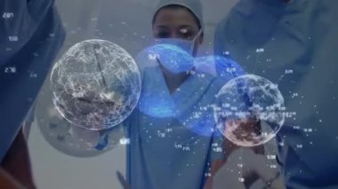 Animation of globes over diverse surgeons with face masks. Global medicine and digital interface concept digitally generated video.