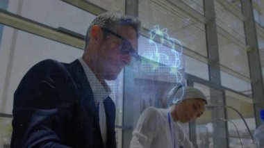 Animation of globe over diverse business people in office. Global business and digital interface concept digitally generated video.