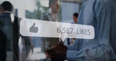 Animation of media icon over african american businessman using smartphone. Global business and digital interface concept digitally generated video.