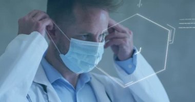 Animation of chemical formula over caucasian male doctor wearing face mask. Global medicine, science and digital interface concept digitally generated video.