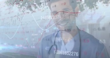 Animation of stock market data processing over caucasian male health worker smiling at hospital. Medical healthcare and technology concept