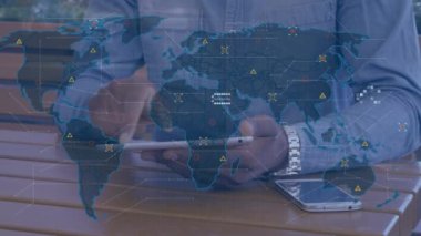 Animation of data processing over world map against mid section of man using digital tablet. Business data and analytics technology concept