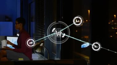 Computer application icons connecting with lines over multiracial coworkers eating at desk. Animation, digital composite, networking, food, teamwork, office, technology and working late concept.