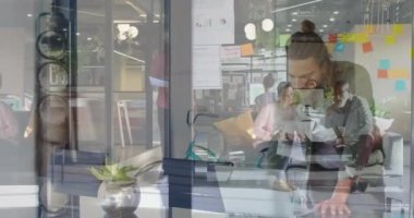 Animation of people in office over caucasian man using laptop. Business, working in office with technology concept digitally generated video.