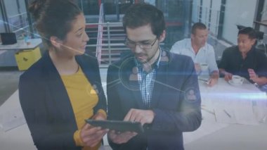 Animation of connections over diverse coworkers with tablet in office. Business, network, connections and technology concept digitally generated video.