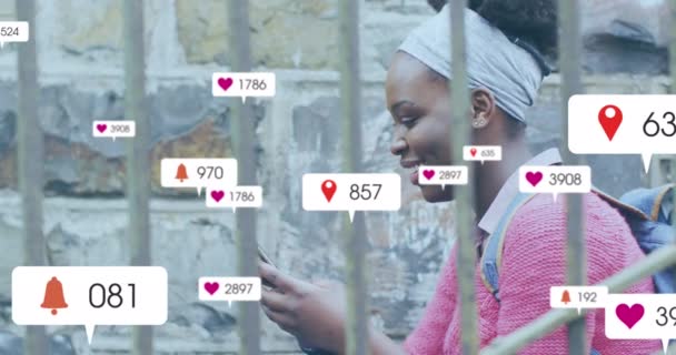 Animation Multiple Social Media Icons African American Woman Using Smartphone — Vídeo de stock