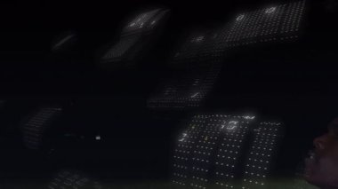 Animation of binary coding over african american male soccer player bicycle kicking ball. Sports and technology concept