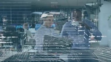 Animation of data processing over diverse businessman and businesswoman discussing at office. Computer interface and business technology concept