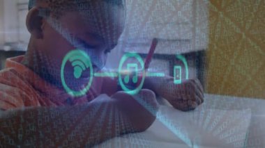 Animation of connected media icons and data over african american schoolboy in classroom. Global communication, education, data sharing and digital interface concept digitally generated video.
