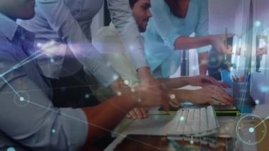 Animation of network of connections over two diverse male and female colleagues using a computer. Global networking and business technology concept