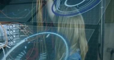 Animation of interface with data processing over caucasian female engineer working at server room. Computer interface and business data storage technology concept