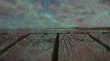 Animation of network of connections over close up of a wooden plank against clouds in sky. Global networking and business technology concept