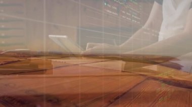 Animation of stock market data processing over farm fields against woman using digital tablet. Global economy and agriculture concept