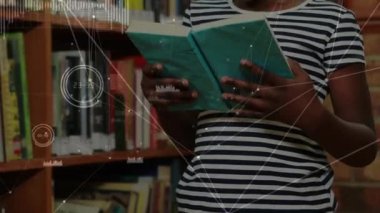 Animation of network of connections over african american girl reading a book in library at school. School and education technology concept