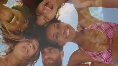 Composite video of low angle view of diverse group of friends smiling against tall trees. Travel and vacation concept