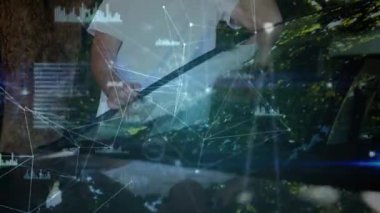 Animation of network of connections over caucasian senior man talking on smartphone in the park. Global networking and business technology concept