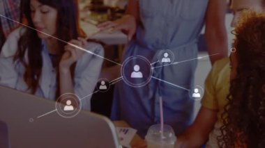 Animation of network of profile icons over portrait of african american woman using laptop at office. Global networking and business technology concept