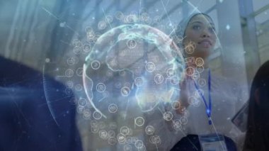 Animation of globe over diverse business people in office. Global business and digital interface concept digitally generated video.