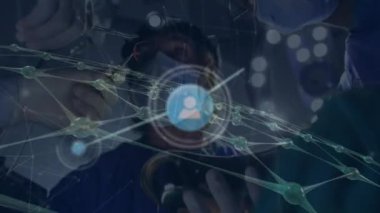 Animation of network of connections over team of diverse surgeons during operation. Health, medicine, connections, network and technology concept digitally generated video.