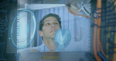 Animation of round scanner and data processing over caucasian male engineer working at server room. Computer interface and business data storage technology concept