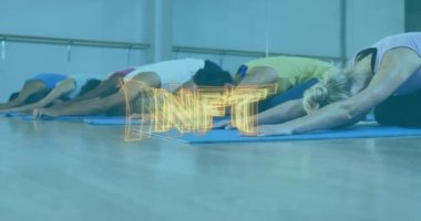 Animation of nft text banner over group of diverse fit people performing stretching exercise at gym. Sports and fitness technology concept