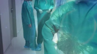 Animation of globe over diverse surgeons with face masks. Global medicine and digital interface concept digitally generated video.