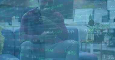 Animation of financial data processing over african american businessman using smartphone. Global business, communication, digital interface and data processing concept digitally generated video.