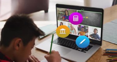 Animation of colorful icons over asian schoolboy using laptop for online lesson. Global social media, icons and digital interface concept digitally generated video.