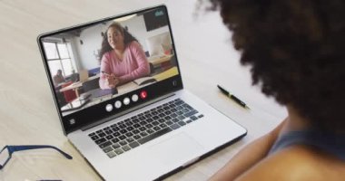 Animation of african american woman having video call on laptop. Business, communication and working in office with technology concept.