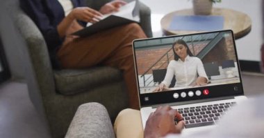 Animation of african american man having video call on laptop. Business, communication and working in office with technology concept.